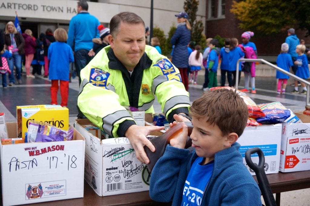 Lt. Eric Rocheleau, who heads the West Hartford Police Department's Community Relations Division, helps sort food. Morley Red Wagon Food Drive, Nov. 9, 2016. Photo credit: Ronni Newton