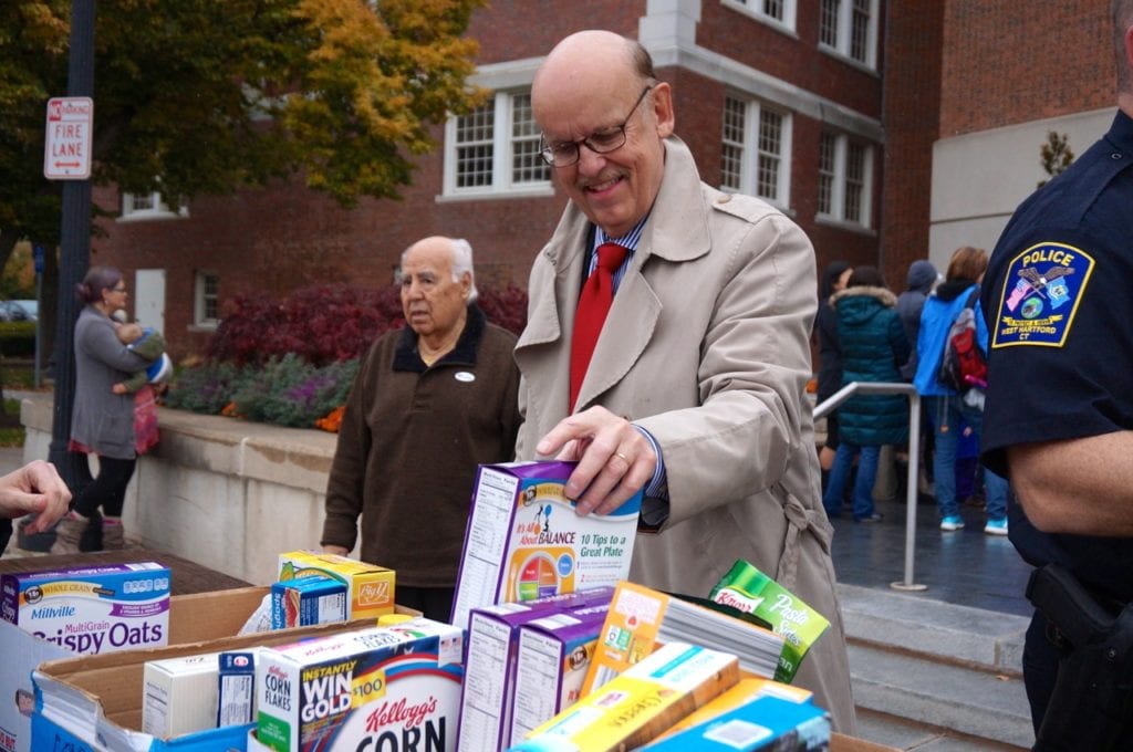 West Hartford Town Manager Ron Van Winkle helps sort food. Morley Red Wagon Food Drive, Nov. 9, 2016. Photo credit: Ronni Newton