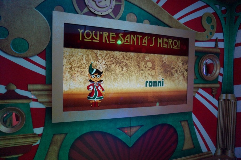Each child (or the we-ha.com editor) gets his/her name displayed on the screen inside the sleigh while dancing in the enchanted snow. Photo credit: Ronni Newton