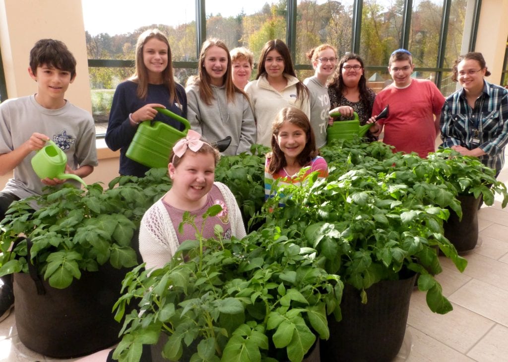 Solomon Schechter community with some of the plants they are growing indoors. Submitted photo