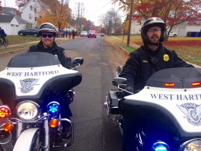 Officer Anthony Miele and Detective Rosario Savastra escorting the kids from Morley. Photo courtesy of West Hartford Police