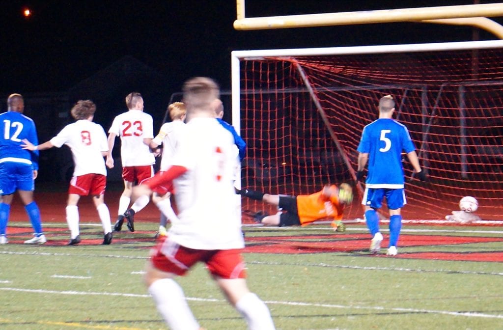 Hall goalie Jeremy Rausch misses a shot by Conard's Will Allen in the first half for the only score of the game. Conard vs. Hall boys soccer. Nov. 1, 2016. Photo credit: Ronni Newton