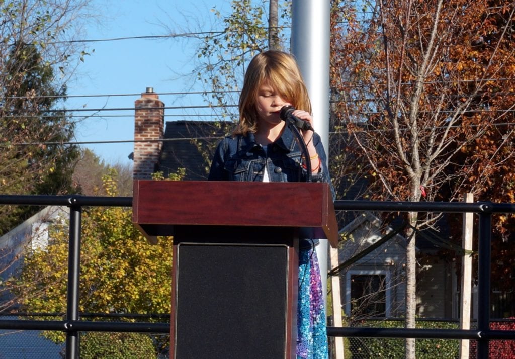 Jayme Kine reads a Veterans Day poem. Veterans Day 2016. Photo credit: Ronni Newton