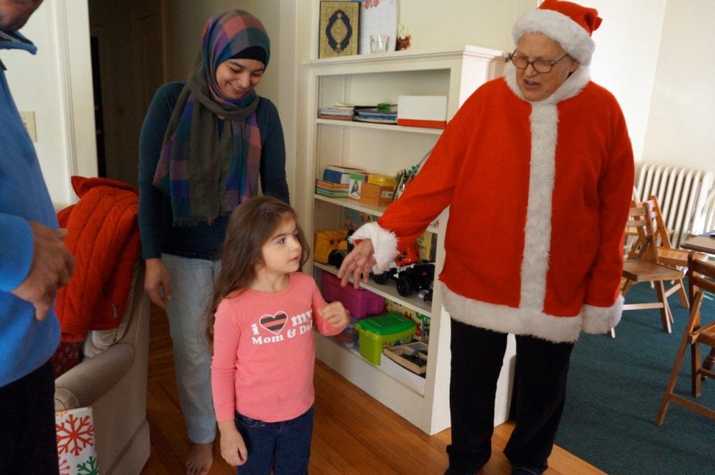 Arabia and Jana Kattoub are greeted by 'Santa' – aka Nancy Latif. Photo credit: Ronni Newton