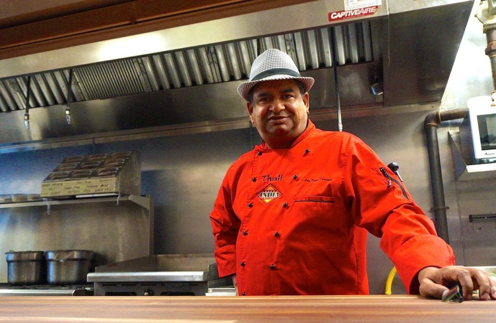 INDIA Restaurant & Bar Chef Prasad Chirnomula stands behind the counter at his newest restaurant, 54 Memorial Rd. in West Hartford's Blue Back Square. Photo credit: Ronni Newton
