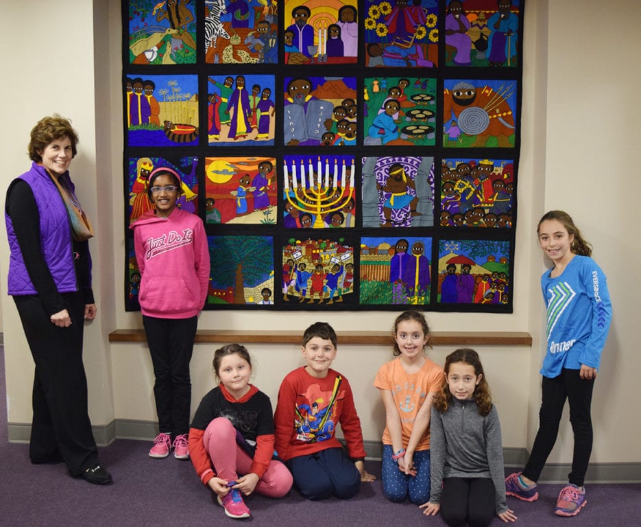 Mandell JCC Member Diane Kruger Cohen with the Ethopian Jewish Quilt and children from the Mandell JCC after school program. Submitted photo