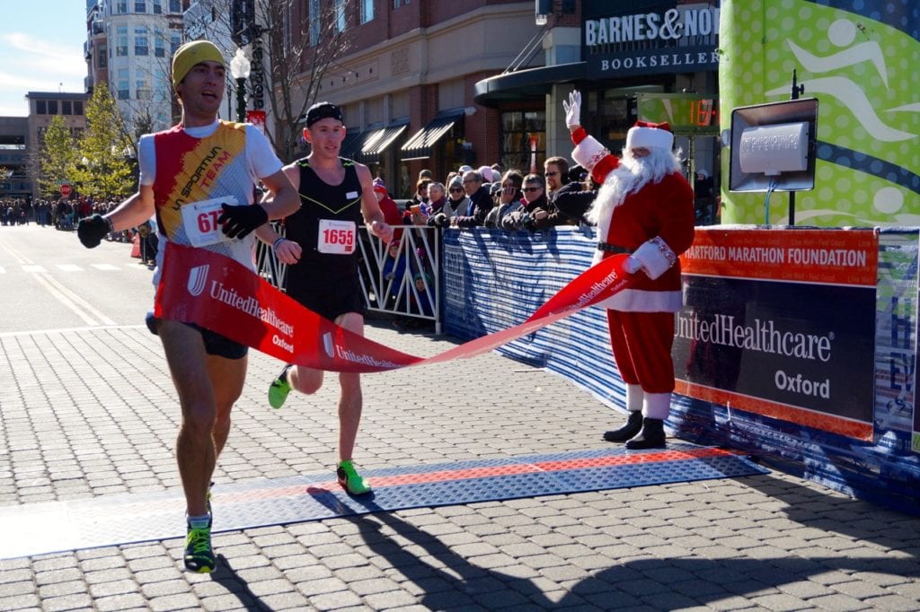 Eric Blake of West Hartford is the first to cross the finish line, followed closely by Joe Gioielli, in the HMF Blue Back Mitten Run, West Hartford, Dec. 4, 2016. Photo credit: Ronni Newton