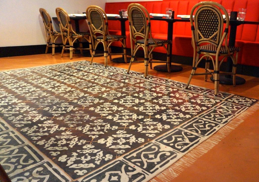 The floor of the dining room appears to be covered with a rug, but it's really a painting. Photo credit: Ronni Newton