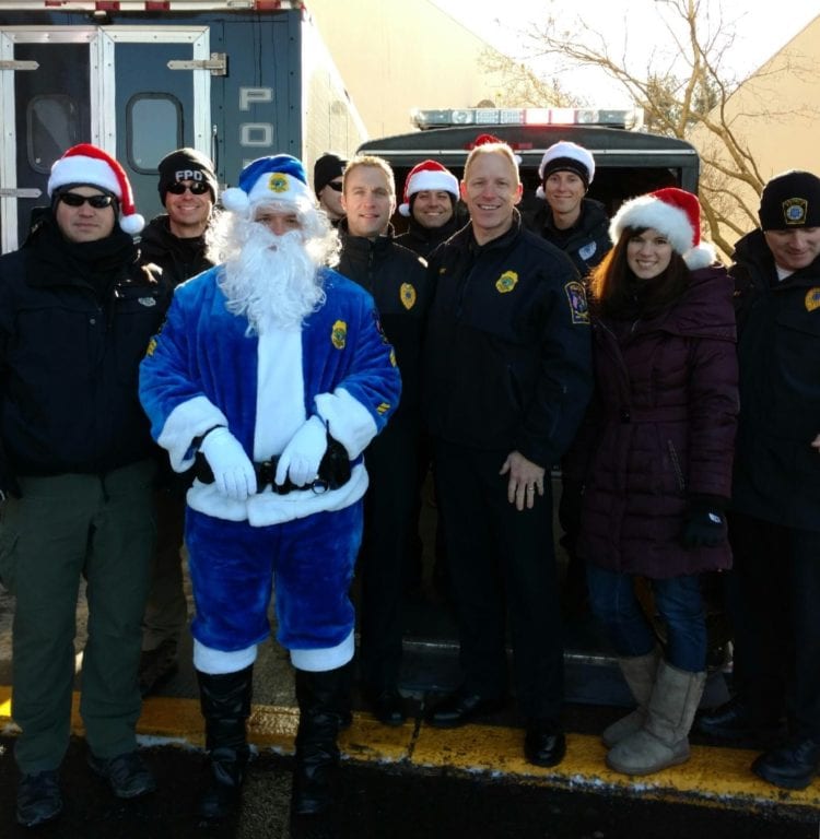 Santa Cop with members of the West Hartford and Farmington Police departments as well as Farmington Chief Paul Melanson (fourth from right) and West Hartford Chief Tracey Gove (next to Chief Melanson). Photo courtesy of Amanda Moffo