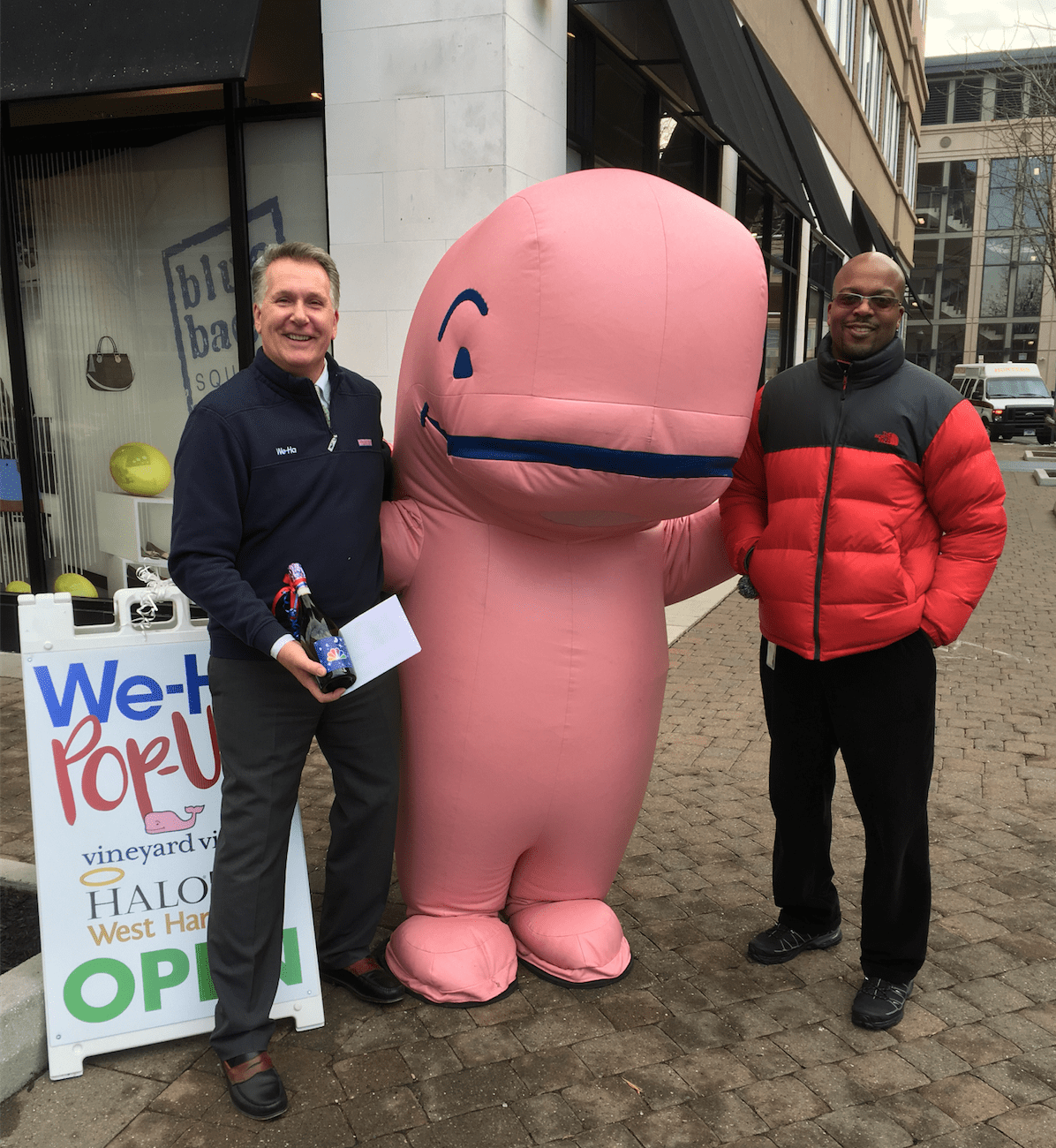 West Hartford Magazine Publisher Tom Hickey and NBC Connecticut Account Manager Anthony J. Wiggins with the Vineyard Vines Whale Mascot at the We-Ha Pop-Up Store in Blue Back Square. Tom is holding a champagne gift from NBC. Photo credit: Joy Taylor