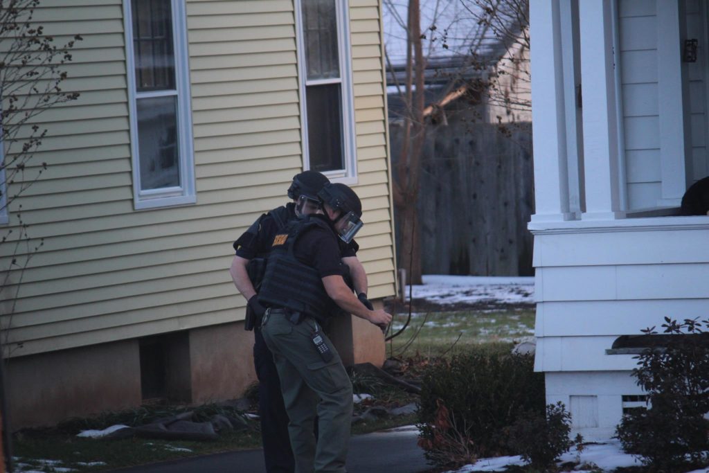 The bomb squad investigates what appears to be a grenade found outside a home at 193 Warrenton Ave. in West Hartford. Photo credit: Patti Albee