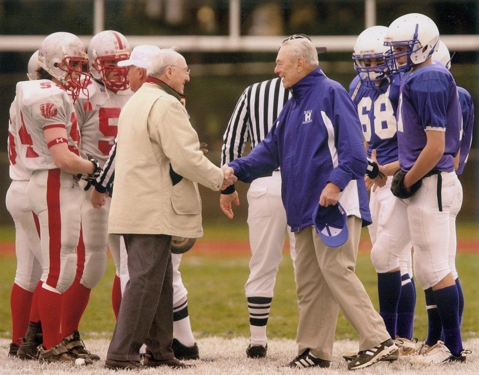 Bob McKee (left) and Frank Robinson II shake hands before the opening coin toss at the 50th annual Conard vs. Hall football game in 2006. Photo courtesy of Curtis Sports (we-ha.com file photo)