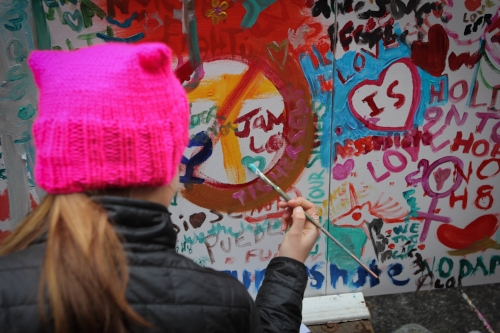 Frankie getting creative on the wall. Women's March on Washington. Photo credit: Sally Wallace Lynch