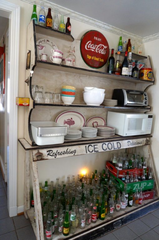 Jim Healy built the shelving now used in his kitchen to showcase the twin Coca-Cola bottle openers that he installed on either side of the "Ice Cold" wording. Photo credit: Ronni Newton