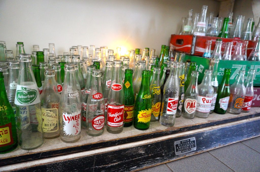 Some of approximately 400 unique glass bottles are displayed on the kitchen shelf in Jim Healy's West Hartford home. Photo credit: Ronni Newton