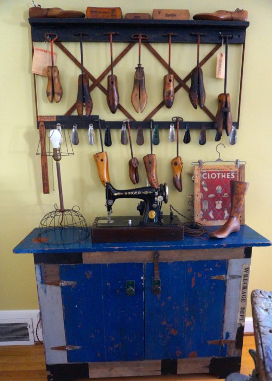 The 1929 sewing machine (which works) sits on a cabinet Jim Healy made from his home's original shutters. His collection of shoe trees and shoe horns hangs above. Photo credit: Ronni Newton 