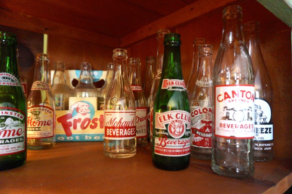 Jim Healy collects glass bottles for the artistic value, and said he likes the graphics. Photo credit: Ronni Newton