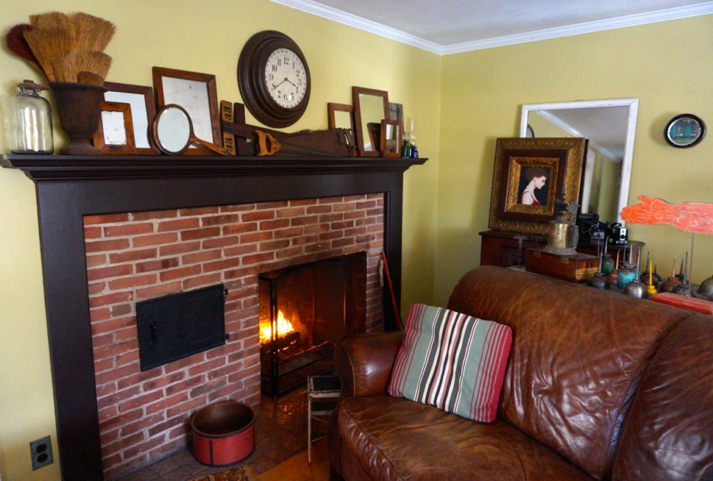 The home's original fireplace serves as a backdrop for some of Jim Healy's collections. Photo credit: Ronni Newton