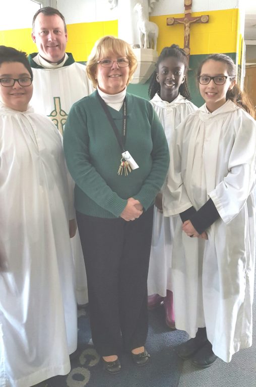 Associate Principal Marge McDonald is surrounded by Father Joseph P. Crowley and her students from St. Brigid-St. Augustine School. Submitted photo
