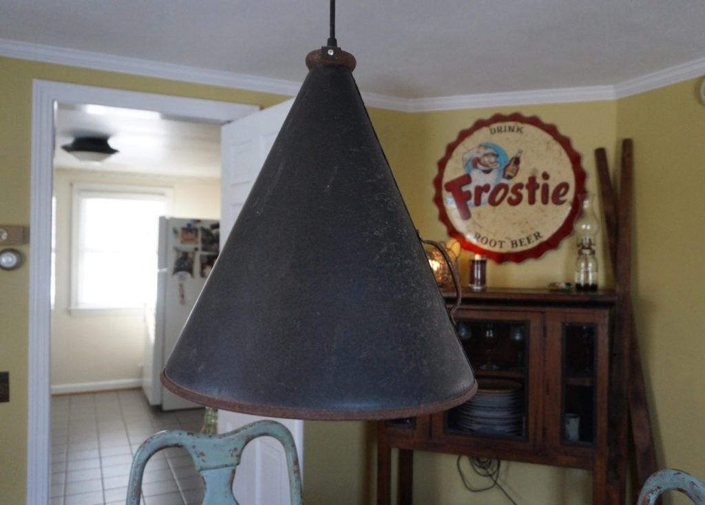 Above the dining room table is lamp Jim Healy made from a repurposed megaphone. Photo credit: Ronni Newton