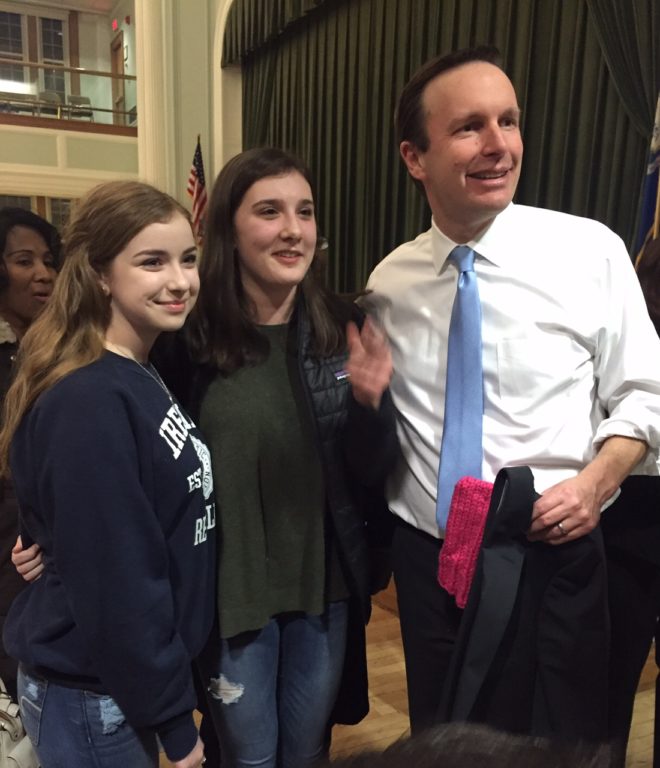 Megan Striff-Cave (center) of West Hartford poses with U.S. Sen. Chris Murphy after the town hall meeting. She wasn't able to get inside for the meeting, but Murphy read and answered her question about becoming politically active as a youth. Photo credit: Ronni Newton
