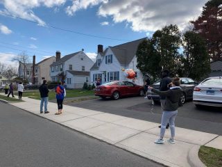 West Hartford neighbors gather outside Peggy Rubb's house to sing "Happy Birthday"