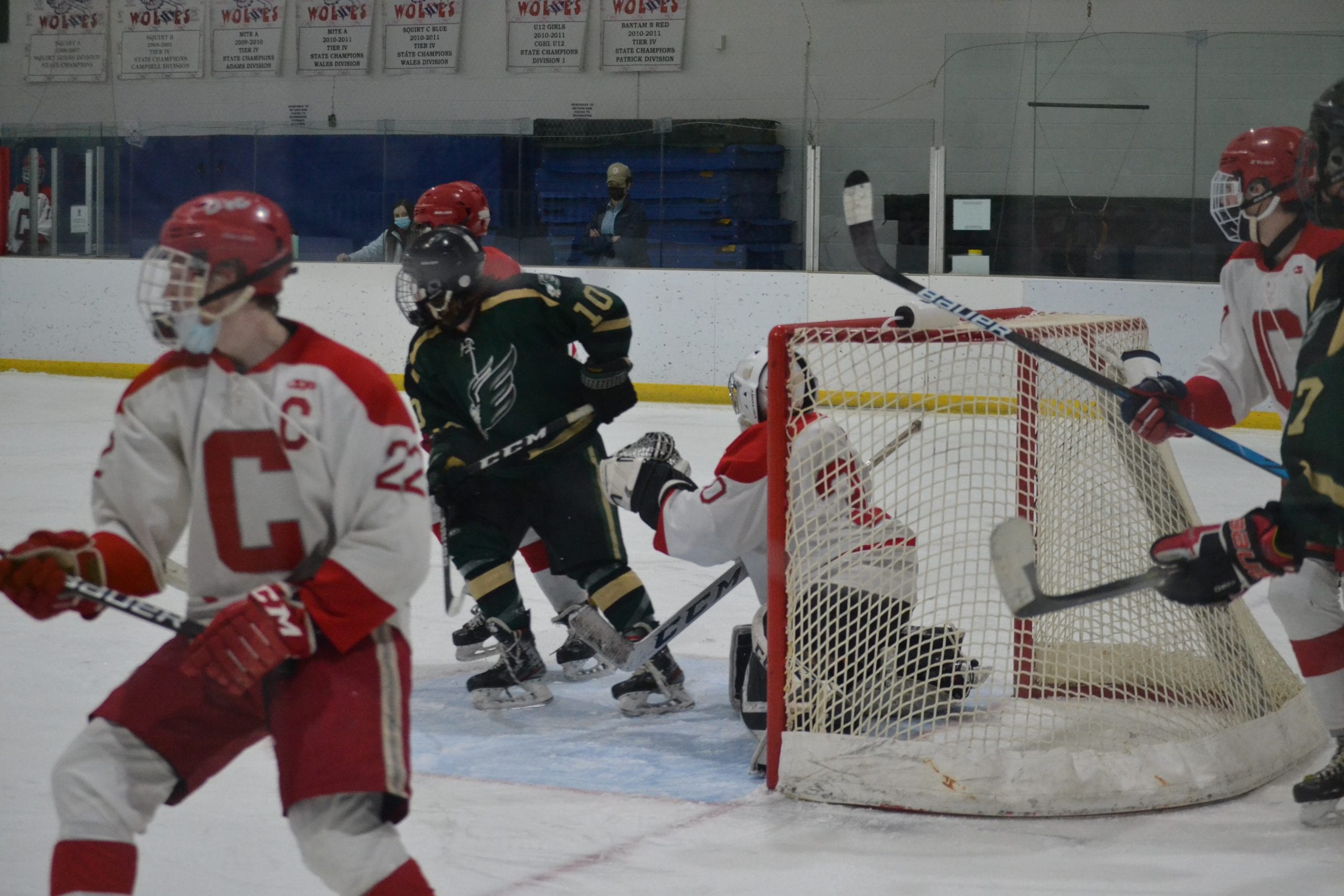 Conard Goalie Graydon Selstad Looks Through Traffic Against Enfield. AsTeammate Colum Flaherty Turns Up Ice