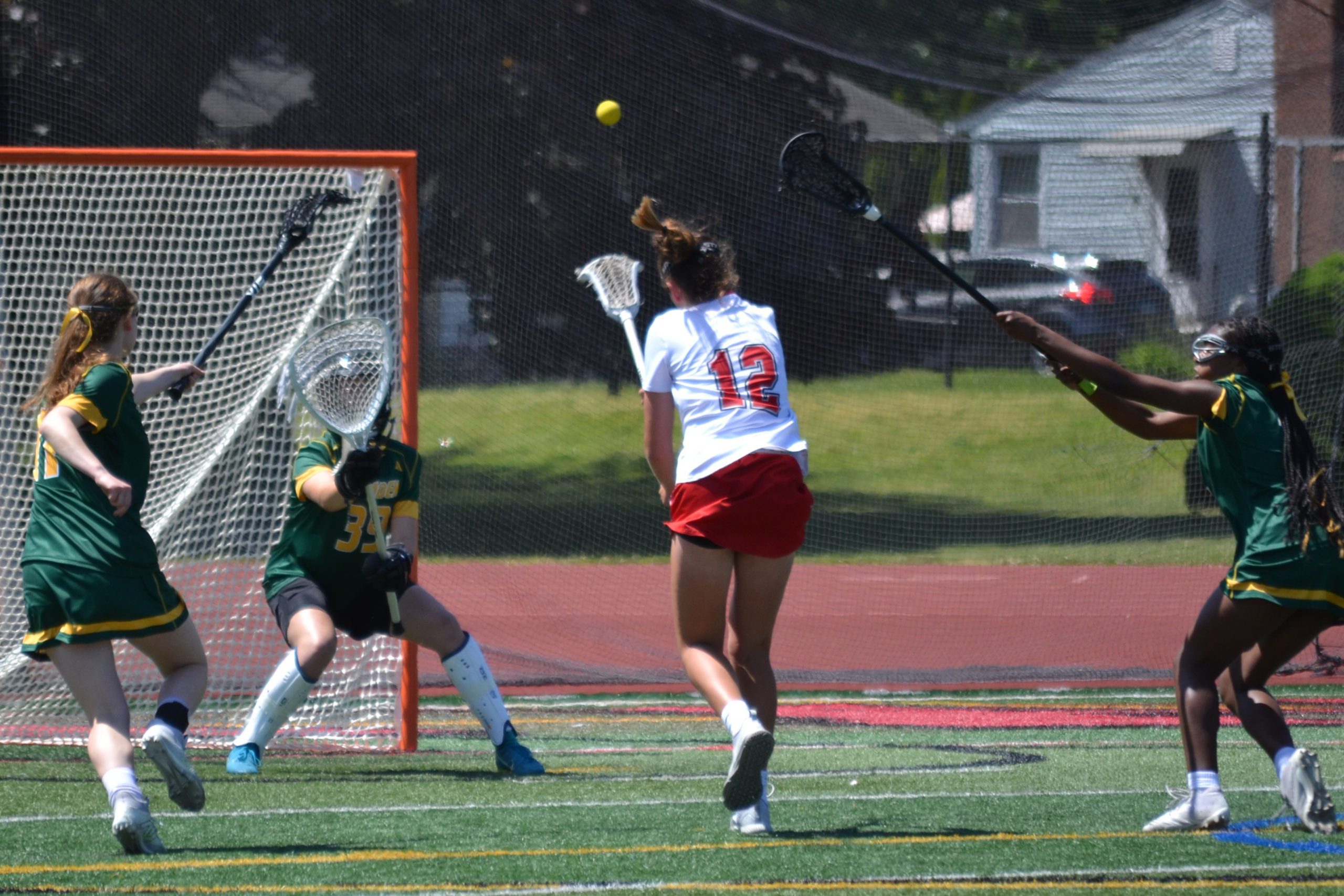 Conard’s Nicole Gorman goes high for the goal against Hamden