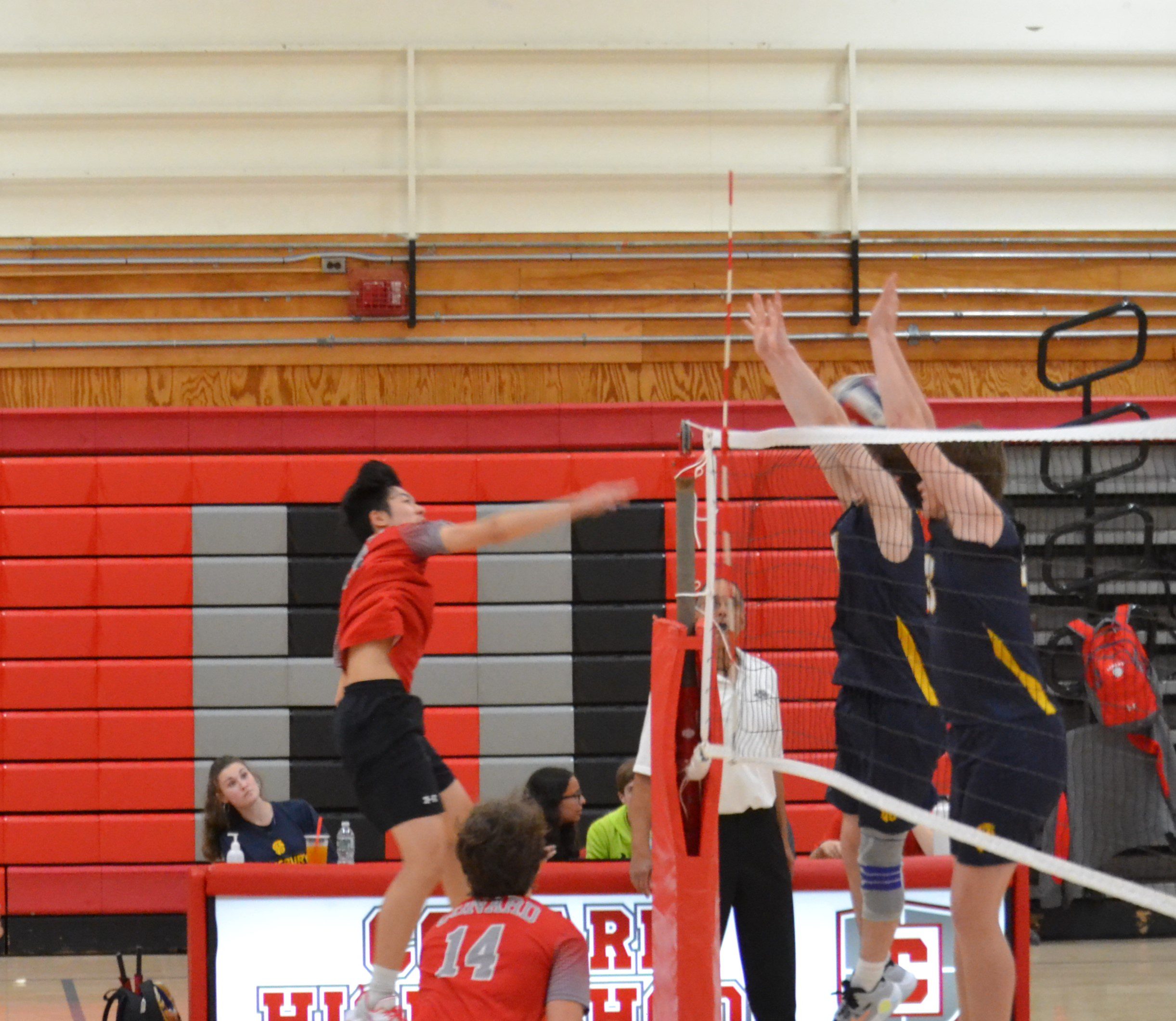 Jayden Du beats the double block for Conard