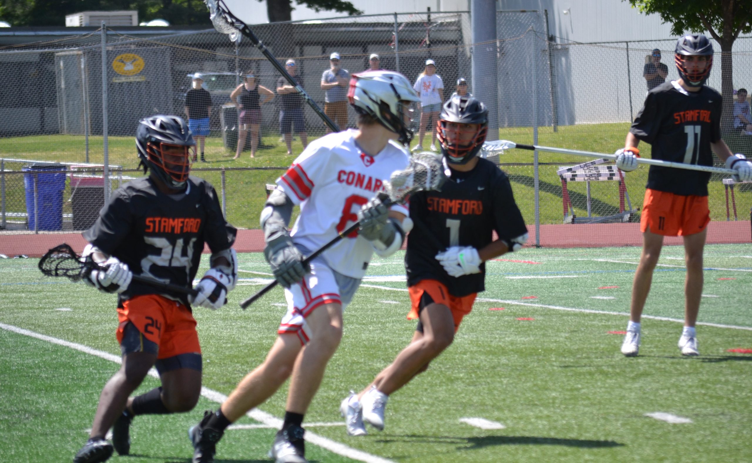 Nolan Trent of Conard works for space between Stamford players