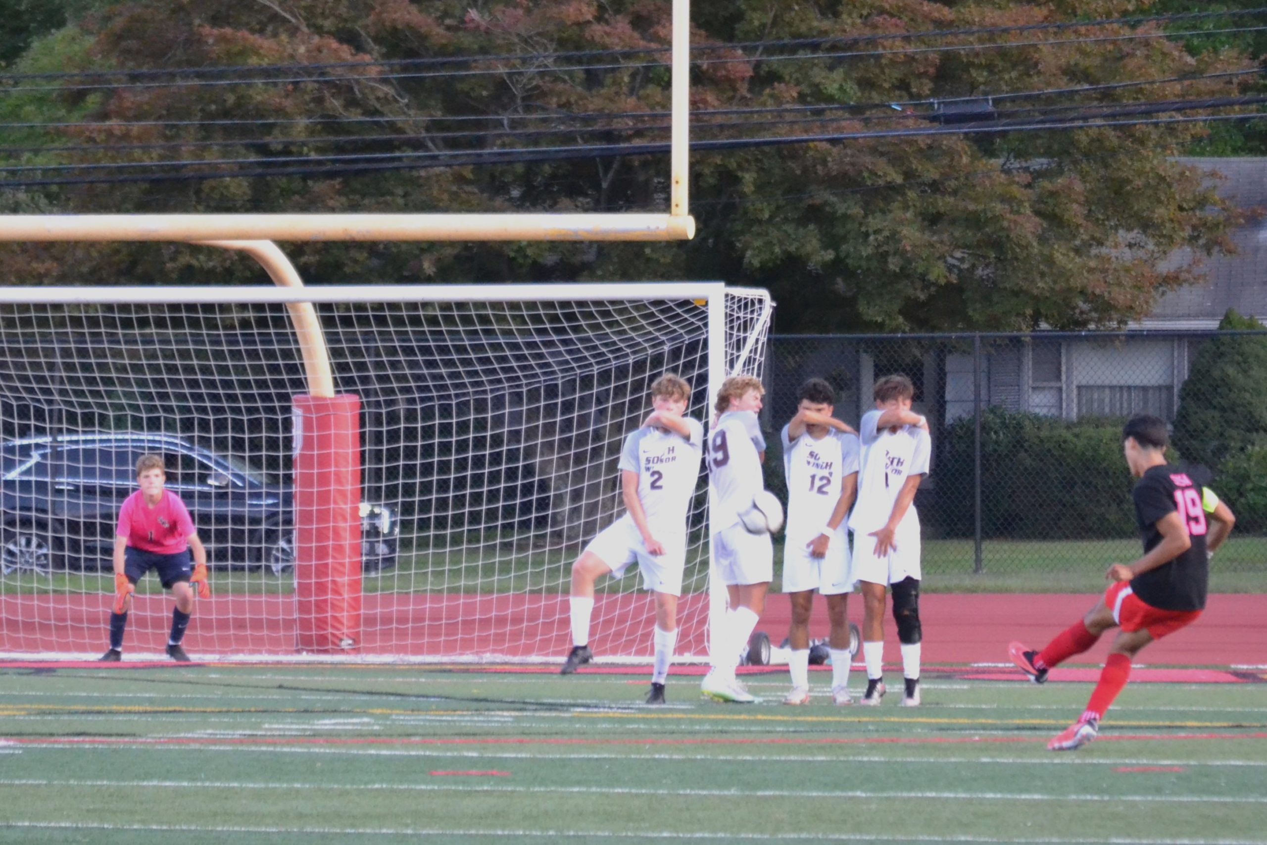 Gabe Sosa’s free kick slams into a wall of defenders. Sosa scored twice for Conard in the 3-3 tie with South Windsor