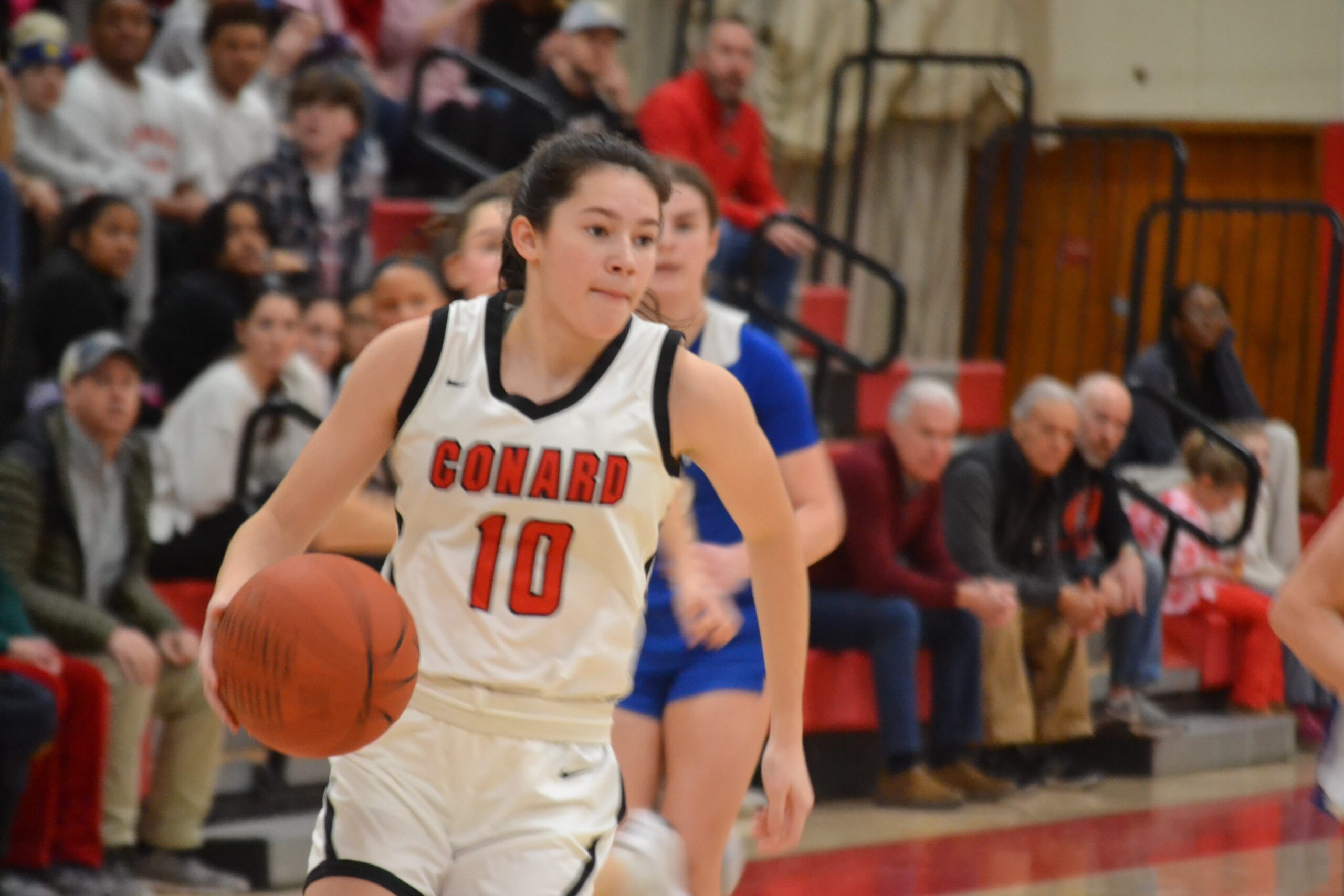 Courtney McPhee of Conard controls the ball for the Red Wolves