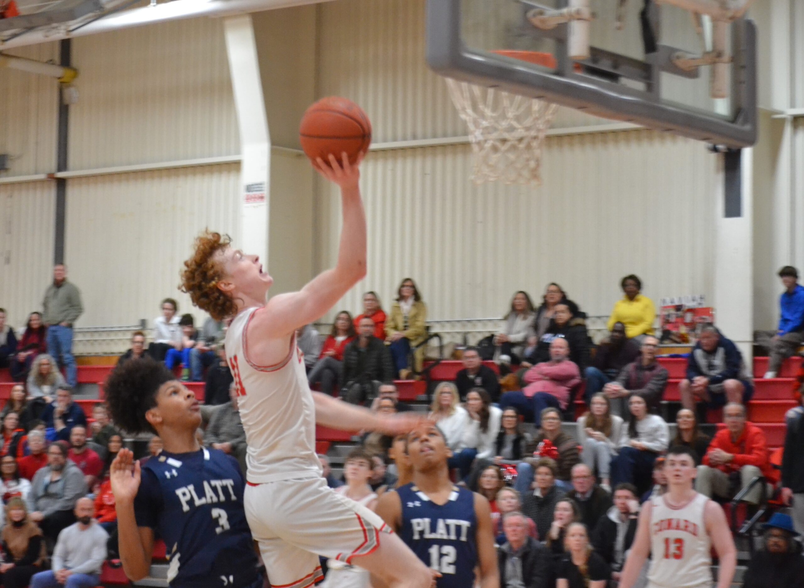 Riley Fox drives to the basket for 2 of his game high 20 points