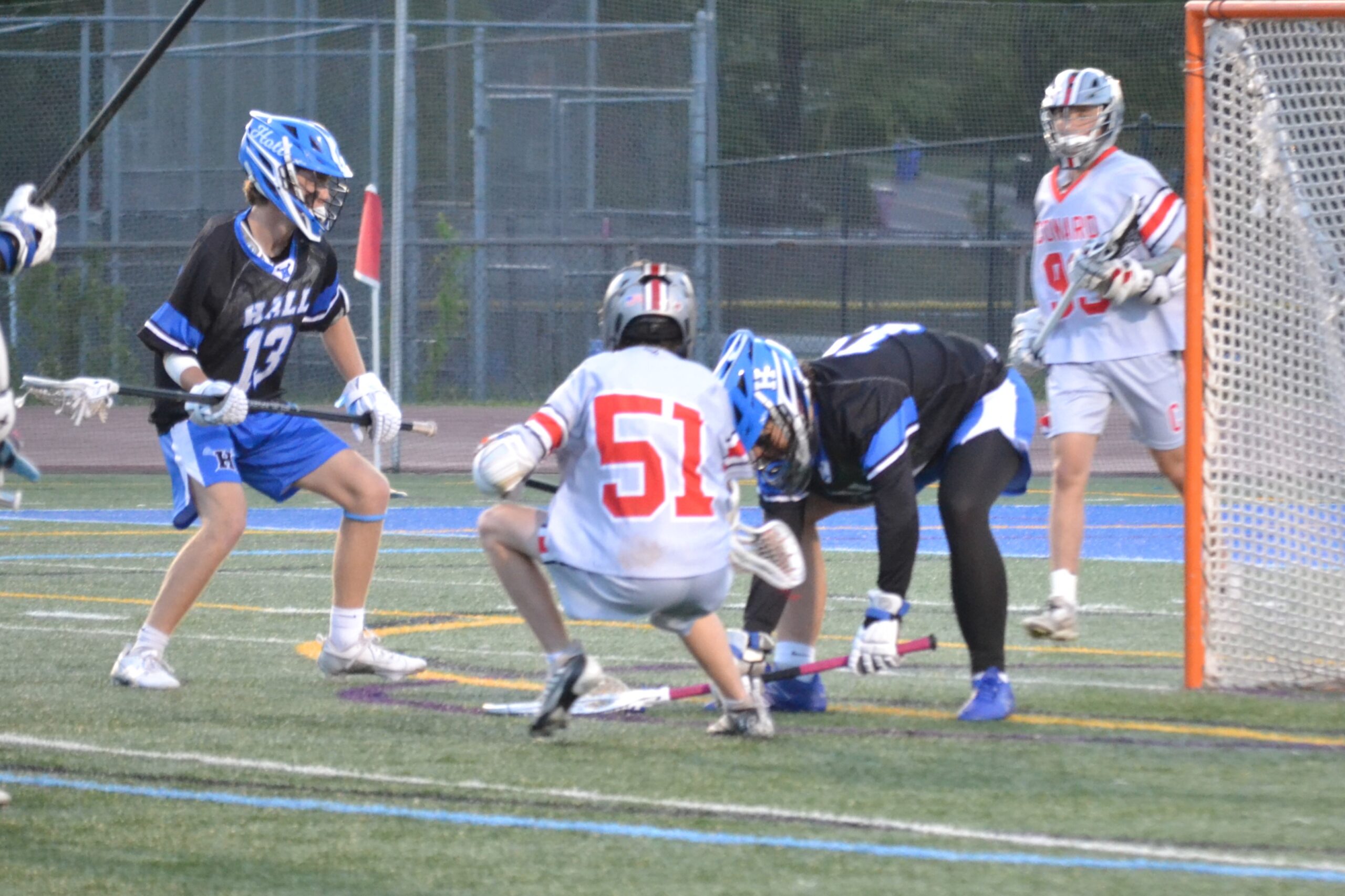 Hall goalie Andy McMullon covers the ball ahead of Conard’s Brady Cersosimo