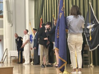 Xavier High School student Ian Hawley receives cord during induction. Photo credit: Roz Green